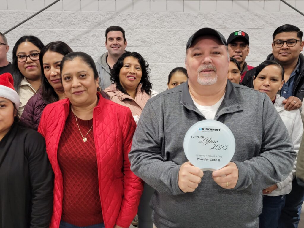 team leader holding an award