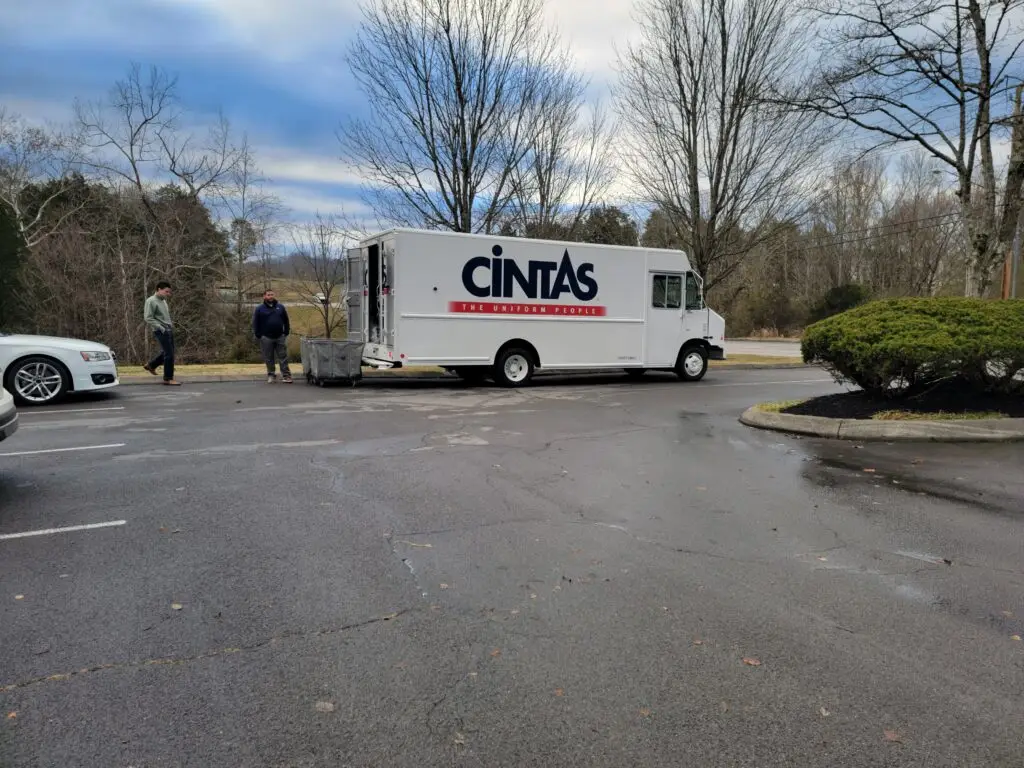 Representatives from CINTAS unloading uniforms.