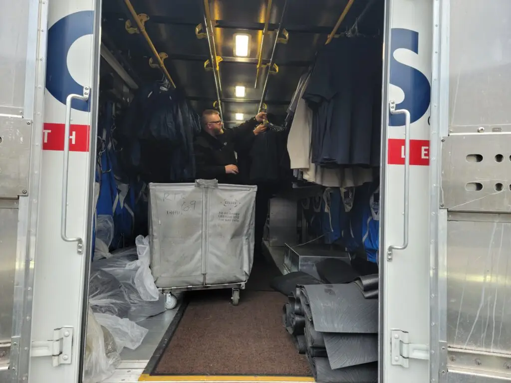 A man unloading uniform from a CINTAS truck to Powder Cote II