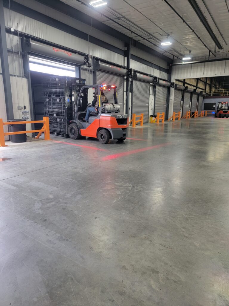 Forklift loading containers in a truck